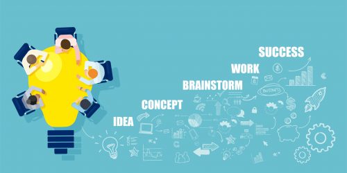 Businesspeople brainstorming successful startup idea sitting at table in a shape of bright light bulb société LLP
